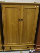 A South African yellow wood two-door wardrobe with drawer below (to match lot 580)