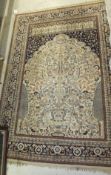 A Persian prayer rug, the shaped centre field with vase and tree of life decoration in cream, taupe,