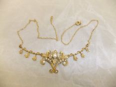 A circa 1900 14 carat gold seed pearl set brooch converted to a necklace,