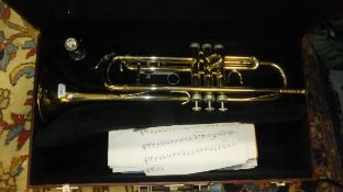 A Holton trumpet in a burgundy coloured carrying case