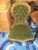 A pair of Victorian carved walnut framed buttoned spoon back ladies and gentleman's salon chairs