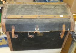 A canvas covered and leather bound dome top trunk containing two wine racks and a metal airer