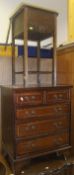 A modern mahogany chest of two short and three long graduated drawers, raised on bracket feet,