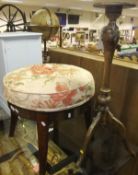 A Victorian mahogany circular stool on four legs,