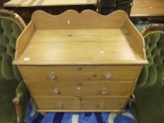 A Victorian pine dressing chest with three quarter gallery over three long drawers to turned feet