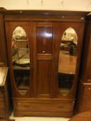 An Edwardian mahogany and inlaid double mirror door wardrobe with drawer on bracket feet