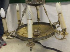 An Edwardian brassed six branch electrolier of circular form with acanthus decorated brass candle