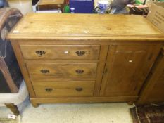 A pine dresser with single door and three drawers on turned feet