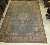 A Persian carpet, the central floral medallion in cream, salmon, pale yellow and pale green on a