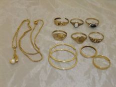 A collection of 9 carat gold rings, a 22 carat gold wedding band and other assorted gold jewellery