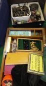 A wooden game box containing a collection of various games and cards to include chess pieces,