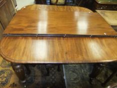 A Victorian mahogany rounded rectangular dining table, the top with moulded edge and two extra