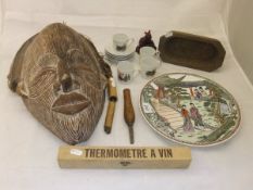 A collection of items to include a carved African mask from Zaire,