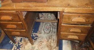 An oak double pedestal desk of six drawers
