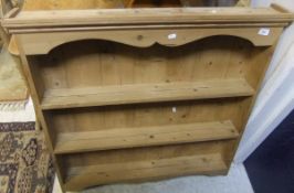 A pine wall hanging three shelf display rack and two spindle back chairs