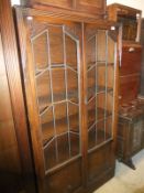 An oak two door glazed oak bookcase,