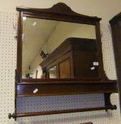 An Edwardian mahogany hall mirror with glove box over a hanging rail