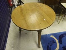 A Victorian pine cricket table on turned supports to castors