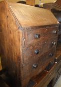 A 19th Century oak three drawer bureau on bracket feet