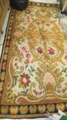 A Kelim carpet decorated with floral motifs in red, orange, yellow, pink and green,