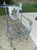 An iron garden elbow chair with shield shaped and pierced back