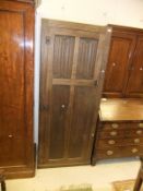 A 20th Century oak hall cupboard with linenfold decorated door