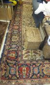 A Persian carpet, the central medallion in dark blue, green, cream and salmon, on a cream ground