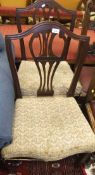 Two mahogany dining chairs with vase shaped back splats and serpentine fronted seats