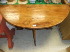A fruitwood demi-lune side table
