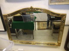 A large modern gilt decorated overmantel mirror