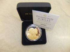 A Guernsey Queen Elizabeth II Diamond Jubilee silver £5 coin with selective gold ink on obverse