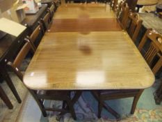 A 20th Century mahogany dining table, the rounded rectangular top with moulded edge on twin pedestal