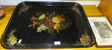 A large rectangular toleware tray painted with flowers on a black ground,