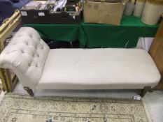 A Victorian chaise longue in a dark cream striped upholstery