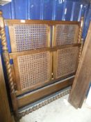 An early 20th century Heals walnut framed and caned bedstead