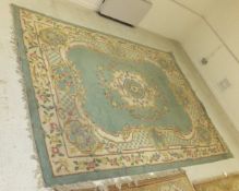 A Persian style carpet, the central medallion in cream, pale blue,