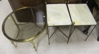A glass topped circular coffee table on brass base,