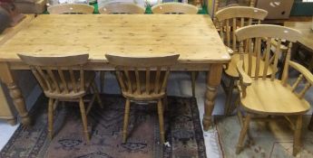 A rectangular pine dining table, together with a set of six (4 + 2) beech seated slat back dining