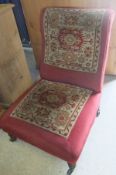 A Victorian salon / nursing chair upholstered with carpet panels in cream and red,