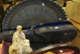 A box containing a large Eastern metal circular tray, a black painted wrought metal footman,