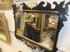 A black and gilt decorated rectangular wall mirror and a mahogany and inlaid overmantel mirror