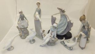 A collection of nine Lladro and other figures to include Lladro girl picking flowers,