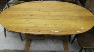 A modern pine oval dining table and a mahogany occasional table