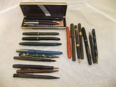 A collection of pens and propelling pencils to include a silver mounted example,