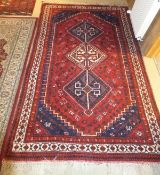 A Caucasian rug, the three central diamond shaped linked medallions in blue, red,