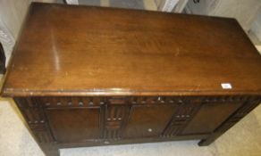 A mid 20th Century oak coffer with walnut veneered panelled front