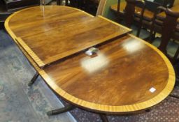 A reproduction Regency style mahogany twin pedestal dining table, crossbanded,