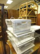 Four white painted bed trays, a wicker bedside cupboard,