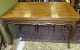 An oak draw leaf table in the French taste