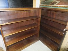 A pair of mahogany open four-shelf book cases on plinth bases